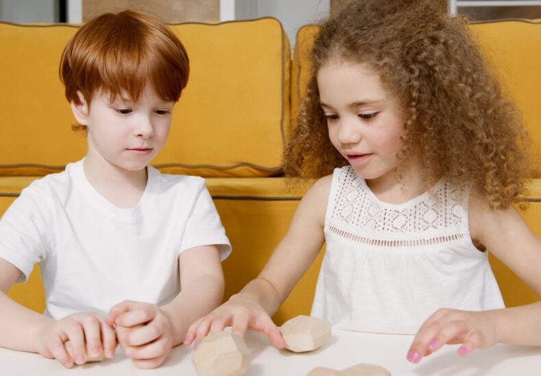 Two children having fun with wooden toys indoors, fostering creativity and play.